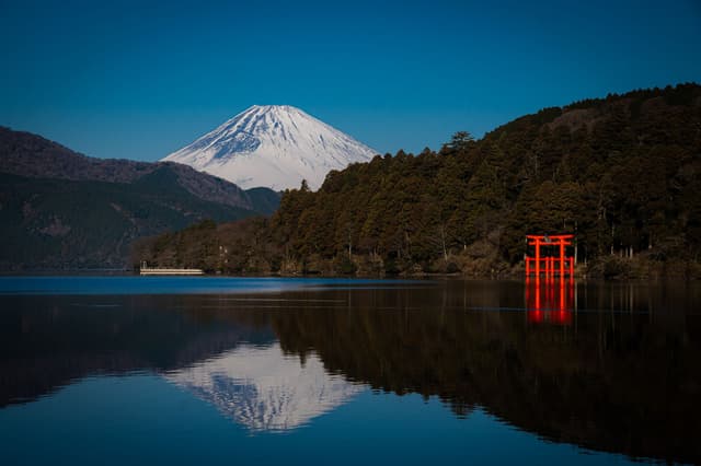 El monte Fuji y el torii rojo del santuario de Hakone reflejados en el lago Ashi